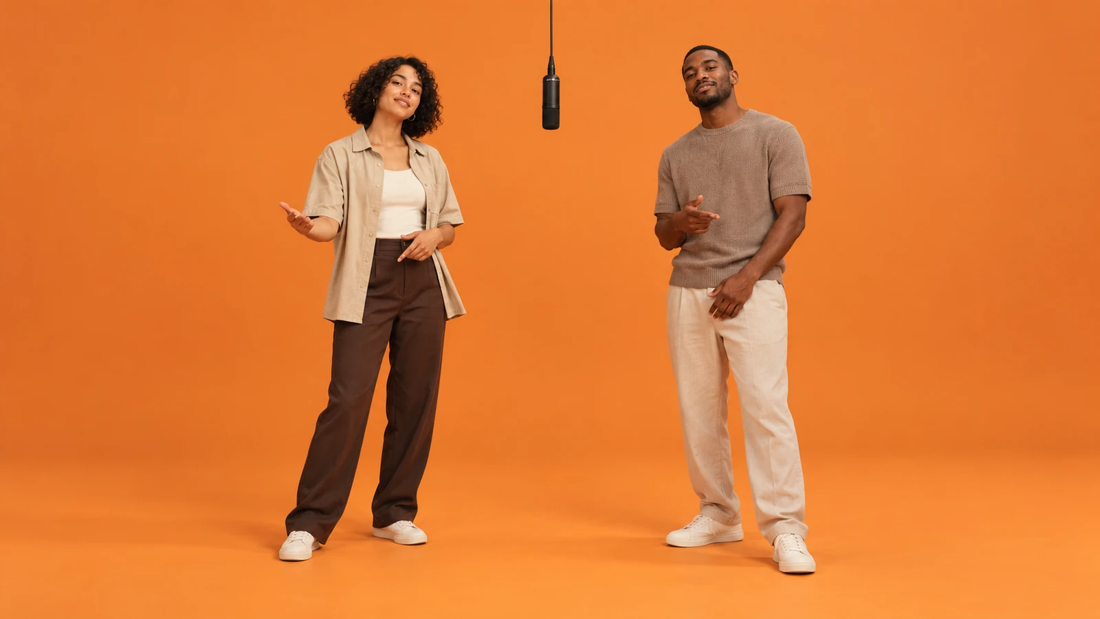 Creator Duo: illustrated orange booth with two performers and a hanging microphone